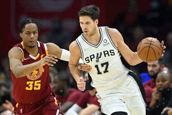 San Antonio Spurs guard Doug McDermott defended by Cleveland Cavaliers guard Isaac Okoro.